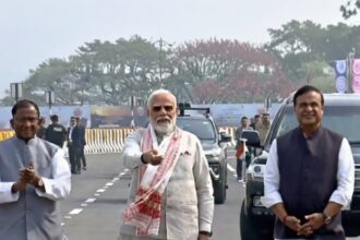 नरेंद्र मोदी असमिया गमोसा पहनकर कुमार भास्कर वर्मा सेतु पर पैदल चलते हुए, असम की सांस्कृतिक विरासत को सम्मान देते हुए।