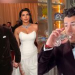 Priyanka Chopra ऑस्कर 2026 के रेड कार्पेट पर व्हाइट गाउन में ग्लैमरस अंदाज में पोज देती हुईं, साथ में Nick Jonas ब्लैक टक्सीडो में नजर आ रहे हैं और उनके हाथ में बंधा कलावा भी दिख रहा है।