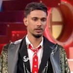 Bigg Boss 20 Reality show contestant in a black stylish jacket and red tie