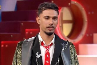 Bigg Boss 20 Reality show contestant in a black stylish jacket and red tie
