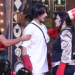 Reality show contestants during a fun challenge on stage