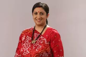 Smiling Indian woman wearing a red traditional saree